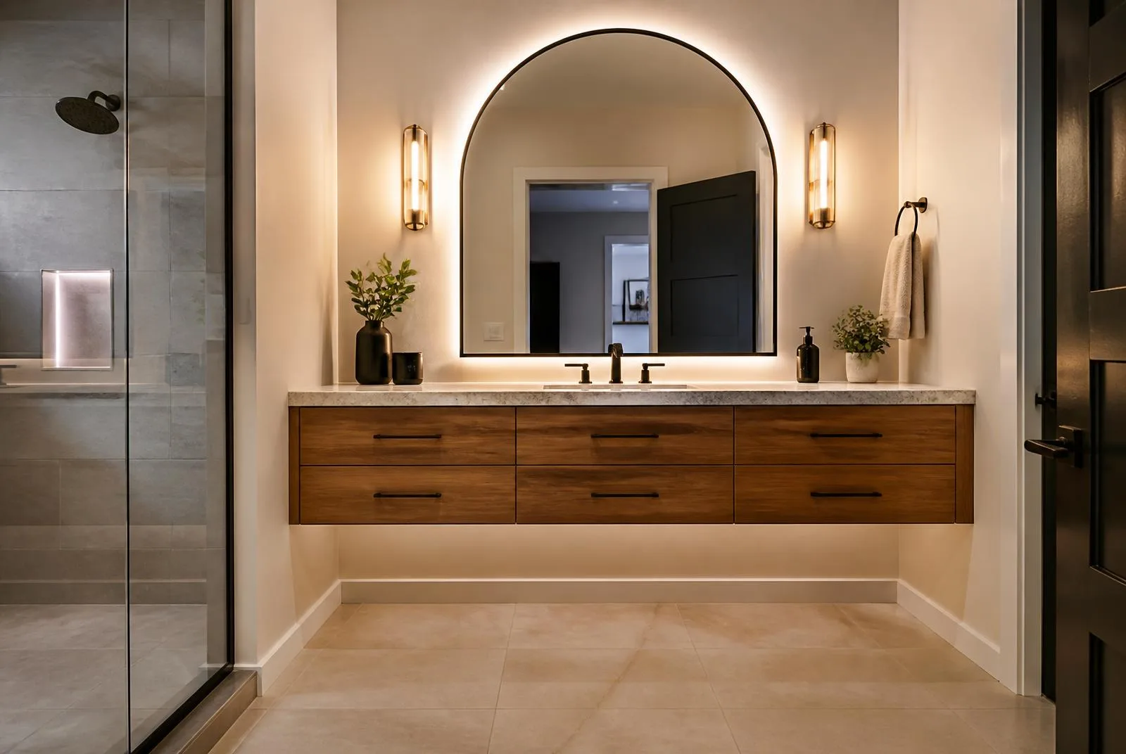 Arched mirror and vanity lighting in finished bathroom remodel