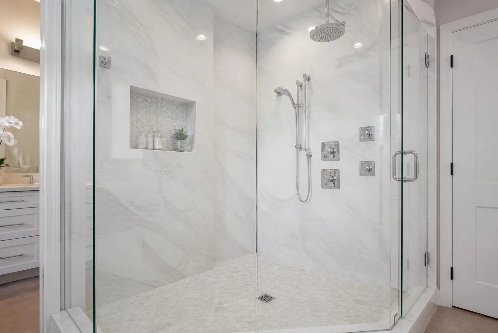 Master bathroom with marble tile walk-in shower and frameless glass enclosure