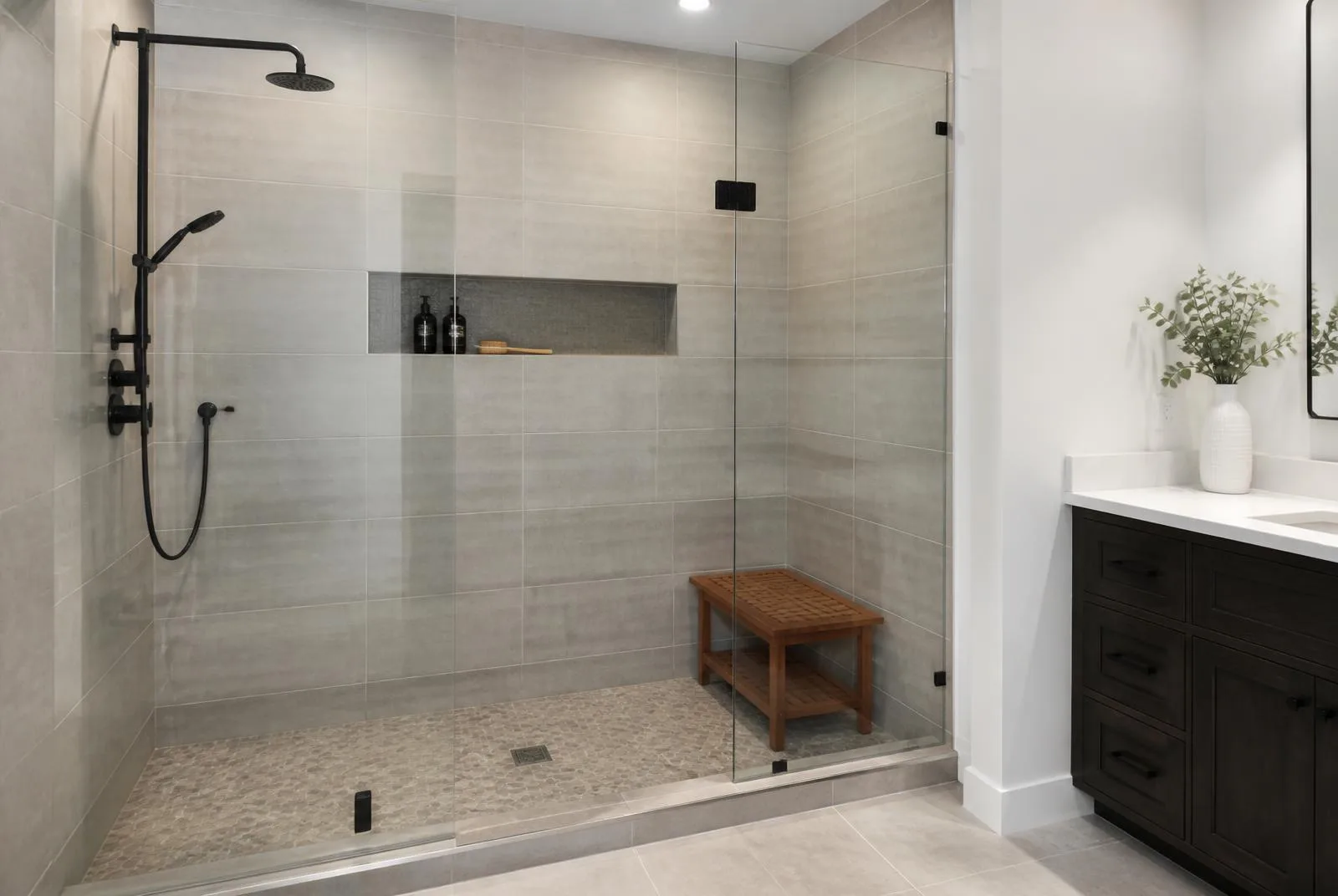 Walk-in shower with tile surround and glass panel
