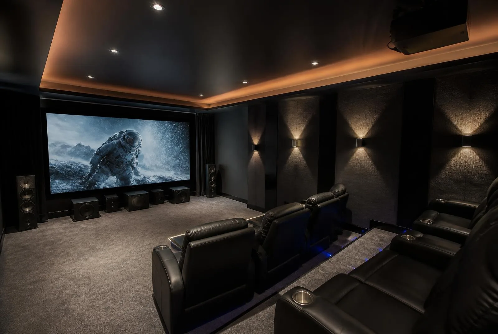 Finished basement home theater with projector screen, tiered recliner seating, and cove lighting